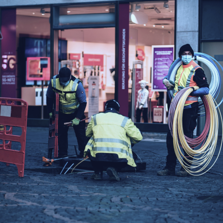 on-field workers installing optic fiber cables